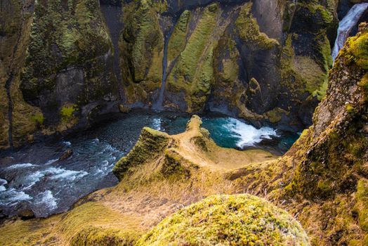 Overlooking a very tall canyon in Iceland with fast flowing river water below scary heights fantastic wow inspiring