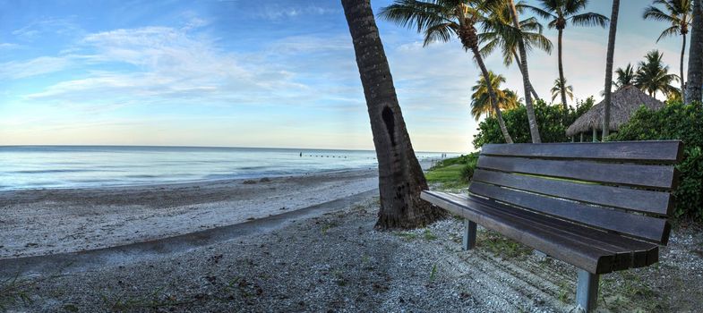 Bench overlooking the ocean at Port Royal Beach in Naples, Florida at sunrise.