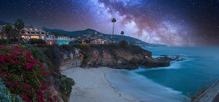 Milky Way over a cliff overlooking the ocean in Laguna Beach, California at sunrise.