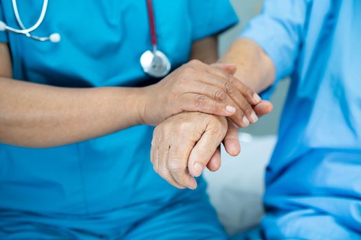 Holding hands Asian senior or elderly old lady woman patient with love, care, encourage and empathy at nursing hospital ward, healthy strong medical concept