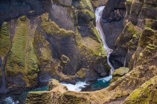 Fjaorargljufur, Iceland mossy green canyon with breathtaking views. Closeup of the river from the top.
