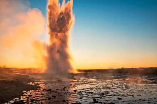 Eruption of the Geysir in Iceland during the sunrise
