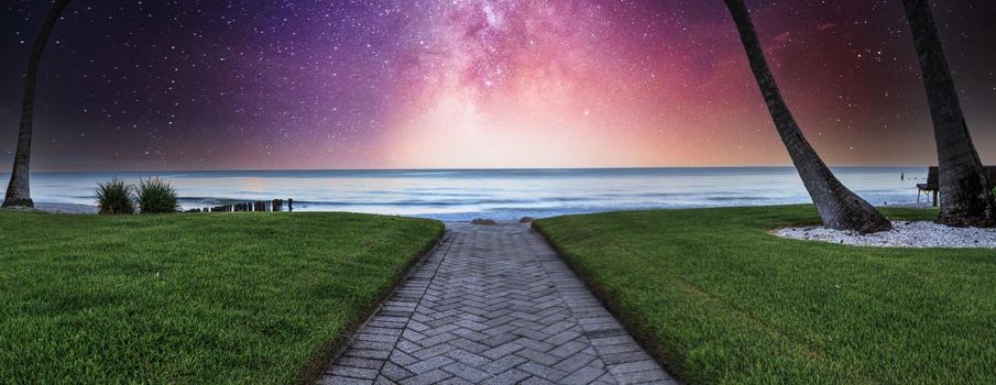 Milky way over Pathway leading to the ocean at Port Royal Beach in Naples, Florida at sunrise.
