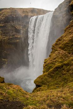 Skogafoss waterfall from the top in Iceland misty spraying atmospheric foggy