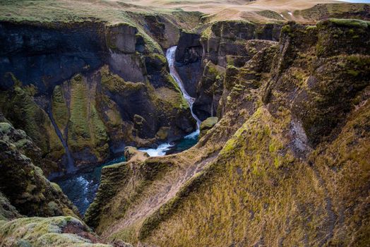 Fjaorargljufur, Iceland mossy green canyon with breathtaking views. Closeup of the river from the top.