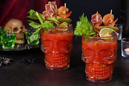 Creepy Halloween party - Caesar or Bloody Mary cocktail containing vodka, some tomato juice, different spices and flavorings, such as Worcestershire sauce, celery. Served with ice in a beer glass 