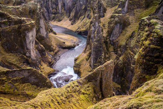 Fjaorargljufur, Iceland mossy green canyon with river flowing and amazing textures.