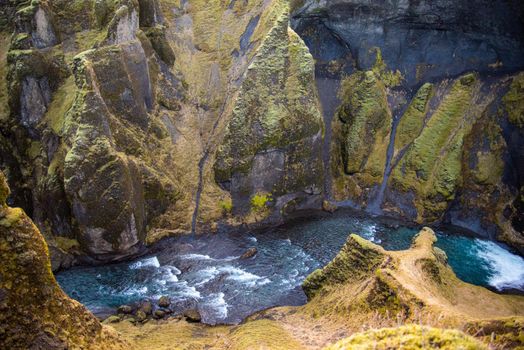 Fjaorargljufur, Iceland mossy green canyon with breathtaking views. Closeup of the river from the top.