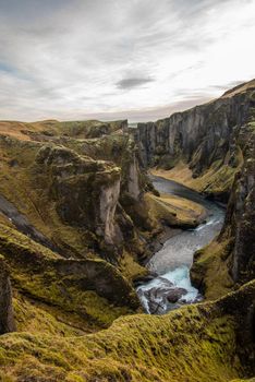 Fjaorargljufur, Iceland mossy green canyon with breathtaking views. Closeup of the river from the top.