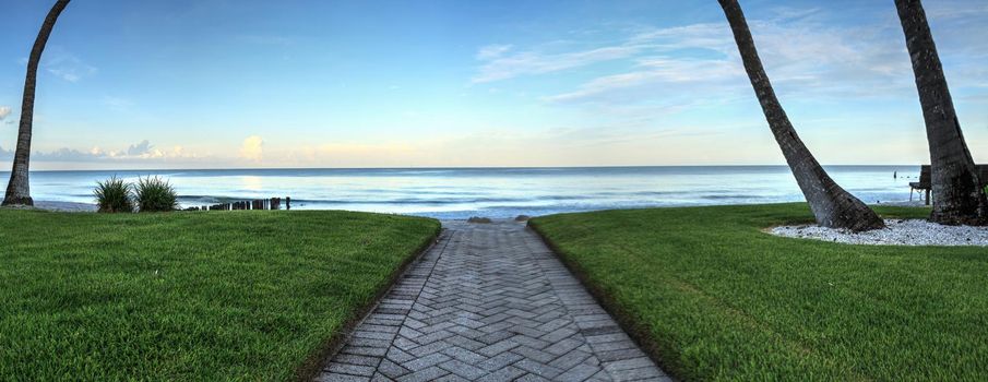 Pathway leading to the ocean at Port Royal Beach in Naples, Florida at sunrise.