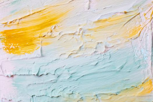 Smears of blue, yellow and white paints on the wall, background or texture