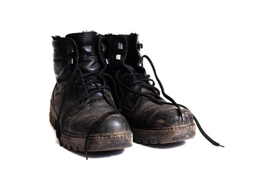 Black dirty men's boots isolated on a white background