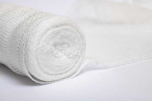 Roll of medical bandage on a white background close up