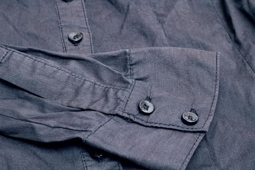 Buttons on a black shirt close up, macro photo