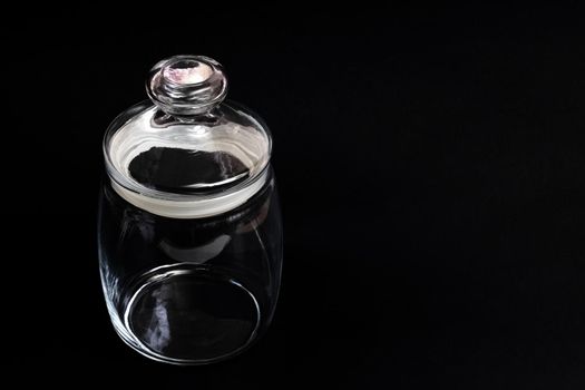 Decorative glass jar on a black background, copy space