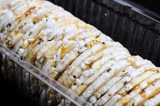White round cookies in a box on a black background close up