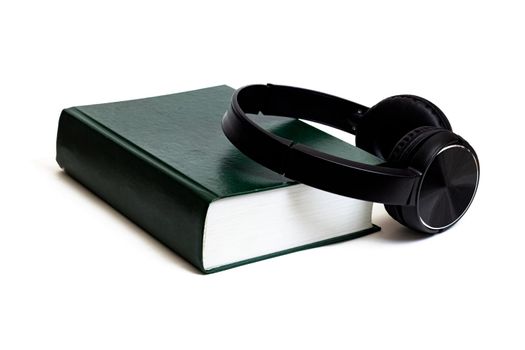 Green paper and headphones isolated on a white background close up