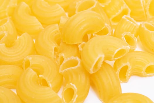 Yellow pasta horns close up, abstract background or texture