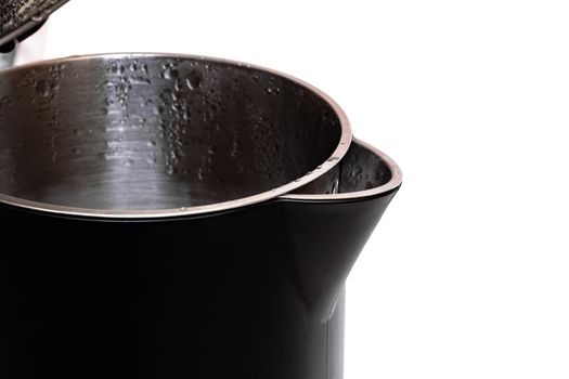 Black open electric kettle close up, isolated on white background