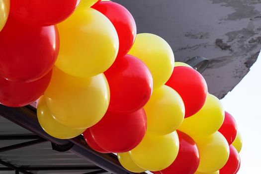 Yellow and red balloons on the building close up