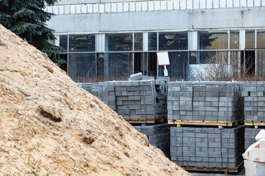 Pile of sand and paving slabs at a construction site