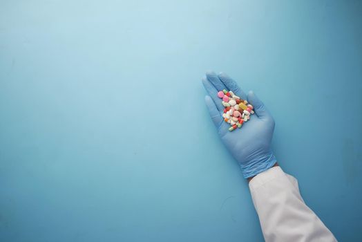 doctor holding medical pill on palm of hand .