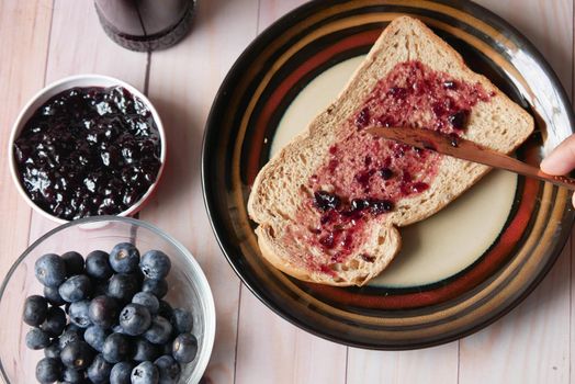 blue berry jam on bread on table