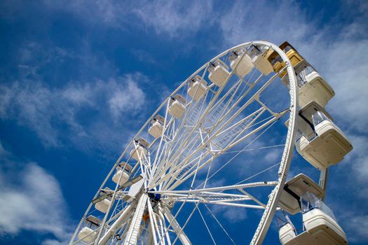 Photo shoot of a white ferris wheel with blue sky background 