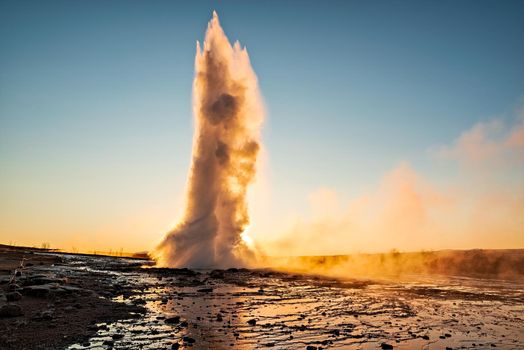 Eruption of the Geysir in Iceland during the sunrise