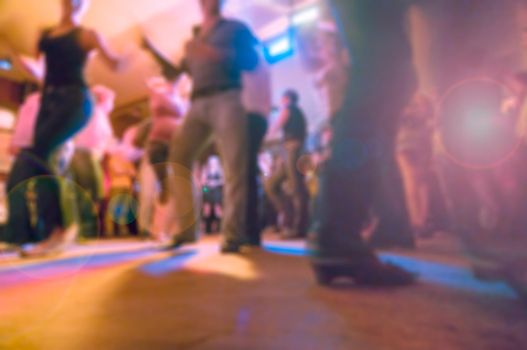 People dancing at the party abstract blur background with bokeh