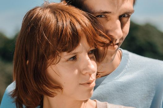 Young romantic couple together in a summer park