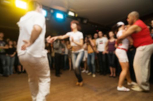 People dancing at the party abstract blur background with bokeh