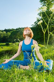 Woman doing yoga asana outdoors in the nature