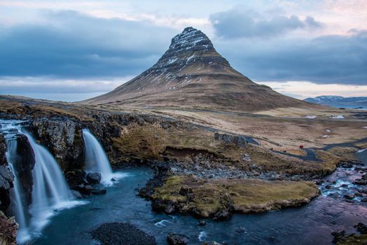 Long exposure at the Snaefellsnes Peninsula landmark view of Snaefellsjokull Volcano. Golden Circle views waterfall flowing dramatic landscape.