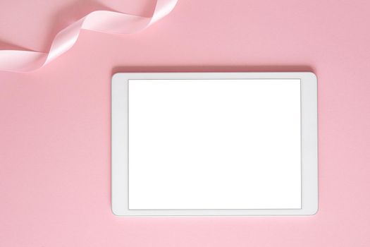iPad pro tablet with white screen on pink color background . Flatlay. Office background top view