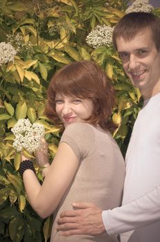 Young romantic couple together in a summer park