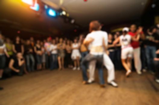 People dancing at the party abstract blur background with bokeh