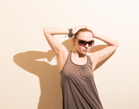 Young slim red woman model wearing sunglasses