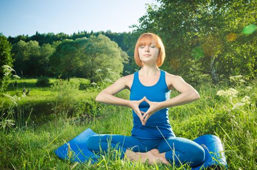 Woman doing yoga asana outdoors in the nature