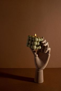 Aromatic scented soy candle with smoke on beige brown textile background , modern bubble candle still life side view