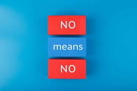 No means no minimal concept. Say no to violence, toxic people, discrimination, agism and other negative factors. Text written on red and blue tablets on blue background with gradient