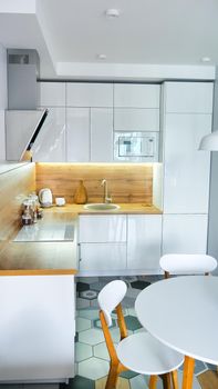 Modern kitchen interior with wooden and white elements, domestic life, home showcase interior concept.