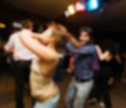People dancing at the party abstract blur background with bokeh