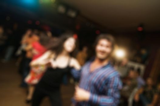 People dancing at the party abstract blur background with bokeh