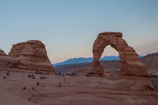 View of the Delicate Arch in Arches National Park Utah at sunset with pastel sky.