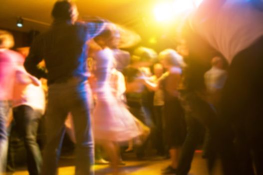 People dancing at the party abstract blur background with bokeh