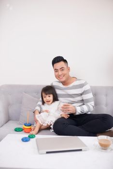 Father and daughter playing with bricks