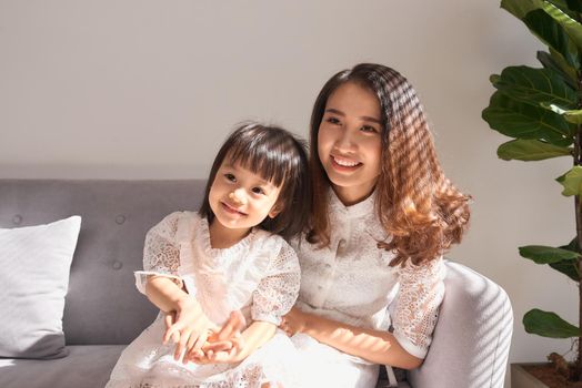 Happy young mother with daughter at home