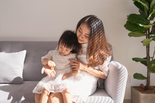 Happy young mother with daughter at home