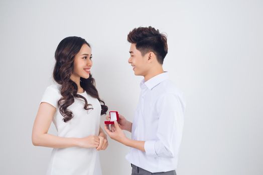 Handsome man showing engagement diamond ring to his girlfriend. Proposed wedding.